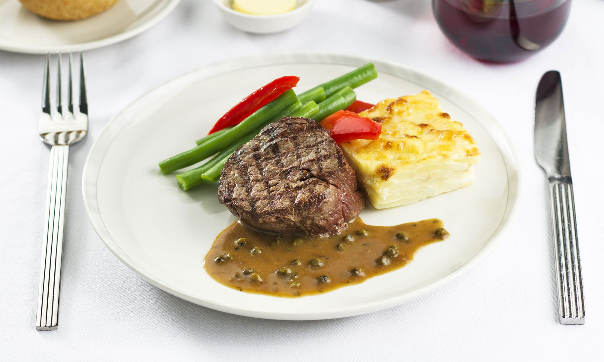 A close view of the Rosemary Beef Brisket on a table on a Singapore airlines' plane